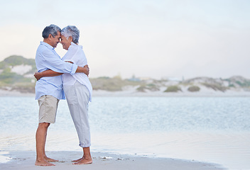 Image showing Senior couple retirement, beach holiday and travel vacation at sea with hug, love and care together. Elderly people in happy marriage, intimate hug and romantic relationship relax at ocean outdoor