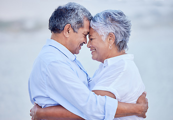 Image showing Travel couple giving hug on beach in nature, man and woman with smile on ocean holiday vacation in retirement and happy senior people with smile by sea in summer. Husband and wife in happiness