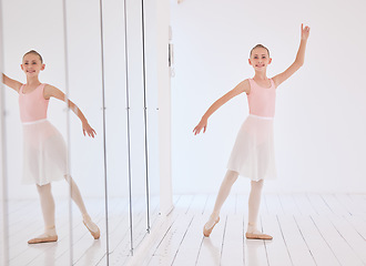 Image showing Happy ballet dancer girl stretching in a dance studio with mirror reflection and portrait. Smile face of a learning child dancing in a class in pink princess costume for a performance
