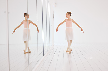 Image showing Fitness, exercise and the art of ballet, young dancer watching herself in a mirror. Happy, confident and learning to love dance and dancing the lifestyle. A ballerina girl training alone in a studio.