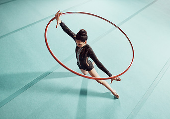 Image showing Gymnastics woman with ring for training, fitness and exercise or workout. Gymnast girl at sport competition event in gym or gymnastic center with motivation, goal and winner mindset top view