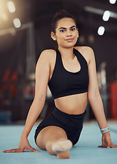 Image showing Dance or gymnastics stretching, sports health exercise and split training before a fitness workout. Portrait of a young woman gymnast or dancer before a sport performance or competition at a gym