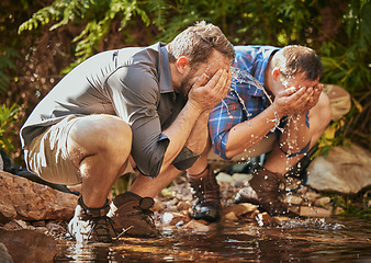 Image showing Hiking men splash water on face for calm, relax and cleaning dirt after trekking on rock or hike in countryside forest. Earth, freedom after camping in nature and travel along mountain river or lake