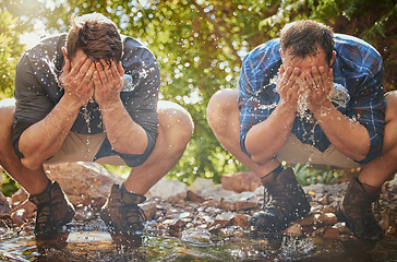 Image showing Hiking men splash face with water for cool, relax and cleaning dirt when trekking on rock or hike in countryside forest. Earth, freedom after camping in nature and travel along mountain river or lake