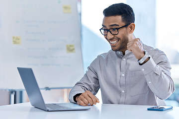 Image showing Happy businessman on a laptop doing a celebration reading email for finance investment profit after success with online deal. Male trading manager or worker excited or joyful after stock market bonus