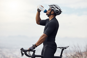 Image showing Sports man with a bike drinking water bottle doing fitness training or workout on sky mockup background. Healthy, professional athlete cyclist with a bicycle during cycling cardio exercise in nature