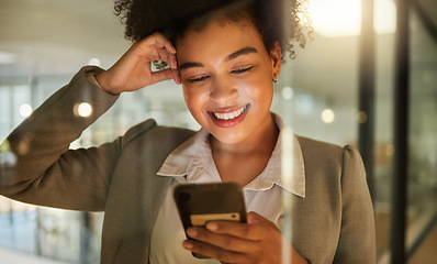 Image showing Business woman on a phone networking on social media, reading a blog or research in corporate office. Working lady browsing internet, company website or mobile app. Happy female texting on smartphone