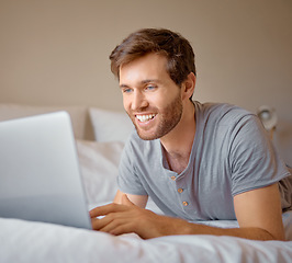 Image showing Happy, smile or man streaming on laptop in home bedroom on movie subscription app or playing esports game. Relax person on house bed searching social media or reading news on communication technology