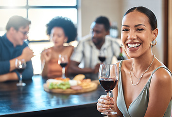 Image showing Social, happy and wine of a woman with a glass of alcohol at a dinner table with friends in a restaurant. Young female with smile in luxury fun dining with people at a celebration or event indoors.