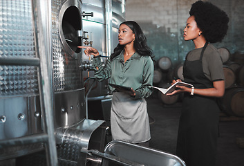 Image showing Agriculture workers at wine farm factory distillery, research steel barrels and talk alcohol drink production process. Farmers in warehouse distillery manufacturing chardonnay or winery industry