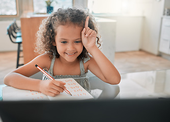 Image showing Education, distance learning child in online class, maths lesson with a laptop, internet or wifi and at home. Smart, happy student raising hand on a video call while writing answer in a notebook