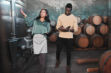 Image showing Man, woman and winemaker giving tour to new employee learning logistics in a winery or wood barrel distillery. Business owner or ceo working at alcohol manufacturing and vineyard startup warehouse