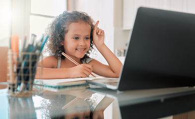 Image showing School, learning and lesson for a little girl e-learning or online homeschooling using home internet and a laptop. An intelligent young child doing virtual self education on a website or app