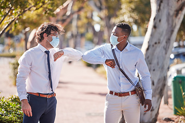 Image showing Businessmen elbow greeting in covid 19 masks outside in a parking lot showing teamwork and diversity in summer. Sun, world and social safety protocol by people who work for a global corporate company