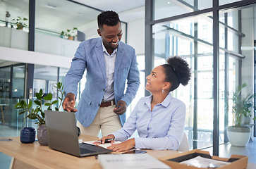 Image showing Training manager with laptop showing businesswoman how to use new software app in the office at a modern company. Smiling male mentor, trainer or boss discussing work project with employee intern