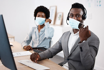 Image showing Customer service workers with protection from covid, mask and good hygiene. Online, call center or IT hotline support employees with headset, social distancing in corona virus pandemic or lockdown