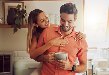 Image showing Happy, in love and carefree couple embracing, bonding and being affectionate at home together. Young boyfriend and girlfriend hugging, relaxing, talking, being playing and enjoying their relationship