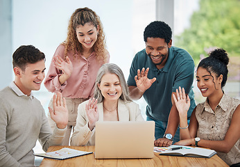 Image showing Diversity, creative and corporate team on a video call while greeting a colleague on a laptop. Team waving at coworker on online zoom meeting. Business people networking on a webinar to do teamwork.