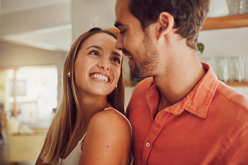 Image showing Couple, smiling and in love having a lovely romantic moment in the kitchen at home. Man and woman spending affectionate free time together, happy and bonding with embraced happiness.