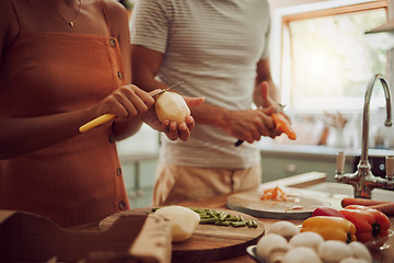 Image showing Health, diet and food of a couple cooking a meal together for lunch in the kitchen at home. Man and woman in a relationship working as a team to cook fresh organic vegetables for healthy nutrition.