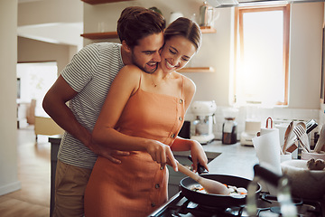Image showing Happy, loving and cooking couple bonding and having fun while spending time together at home. Playful, fun and smilinghusband and wife hugging while preparing a meal and sharing a romantic moment