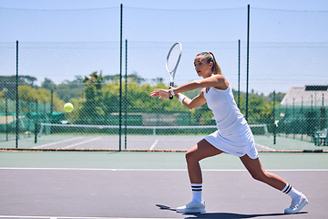 Image showing Fitness, exercise and sport with training tennis player playing competitive match at a tennis court. Woman athlete practicing cardio in a game. Young, strong player enjoying action and competition