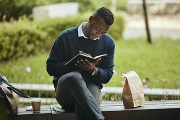 Image showing Writing, creative thinking and planning businessman sitting on park bench working on corporate strategy. Employee man taking lunch break from office to work on schedule and write in a notebook.