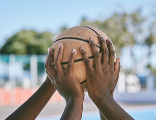 Image showing Teamwork, support and hands holding basketball start sports competition, game and league match. Black community of athlete playing, training and competing on outdoor court for good sportsmanship