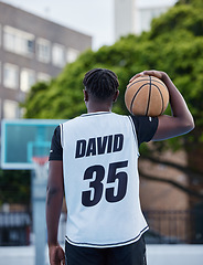 Image showing Basketball, sports and fitness exercise of a sport player on an outdoors court for a workout. Back of a strong man and athlete with a ball ready to start cardio, active or game match training outside