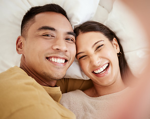 Image showing A happy and in love couple taking a selfie while smiling, laughing and looking cute portrait. Romantic, fun and sweet boyfriend and girlfriend bonding, relaxing and enjoying quality together in bed