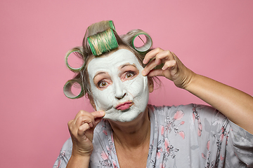 Image showing funny senior women with clay face mask