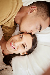 Image showing Happy, smiling and affectionate young couple in love taking a selfie together in the bed at home. Portrait of loving female taking a photo in happiness while her partner is sleeping during the day.