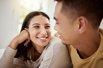 Image showing Happy, carefree and smiling couple relaxing together at home and spending quality time. Relaxed, loving and excited lovers having fun and cuddling in the house enjoying being affectionate