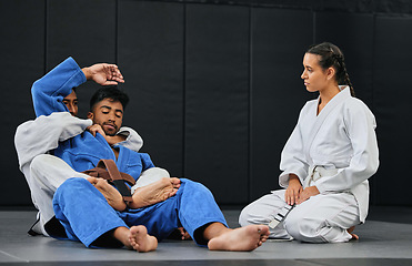 Image showing Group of athletes in a martial arts fight workout for fitness at a training studio. Active, fit and diverse team of sporty people practicing sparring in taekwondo or jujutsu at an exercise dojo.