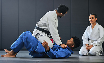 Image showing Karate, fitness and martial arts instructor teaching a lesson on fighting and defense training at a gym or indoor center. Diverse sporty student learning how to be safe in an attack with tough coach