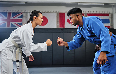 Image showing Karate, mma and fitness with a teacher and student learning, training and doing a workout for exercise, sport and health. Man and woman in fight, combat or self defense class in a gym studio