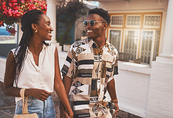 Image showing Happy, relax and in love couple walking in small town or city street on their holiday date in spring time. Travel, summer and smile man and woman holding hands on tourism vacation trip