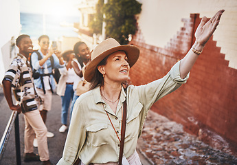 Image showing Travel, education and a teacher with students on school field trip, on urban tour. Woman, city guide and group of happy tourists, pointing at local architecture and learning on international holiday.