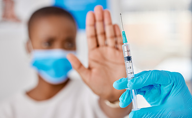 Image showing Vaccine hesitancy, covid and female patient stopping doctor from giving the injection at the clinic. Woman refusing to take the vaccination while a healthcare worker prepares the needle and syringe.