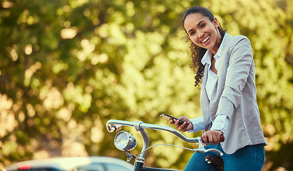 Image showing Business woman, travel with bike and phone in sustainable environment or park with trees. Sustainability corporate worker portrait, bicycle and digital carbon footprint for green, healthy lifestyle