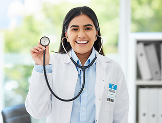 Image showing Healthcare, medicine and a happy doctor, woman in her office with a smile and a stethoscope. Vision, success and empowerment, portrait of a female medical professional or health care employee at work