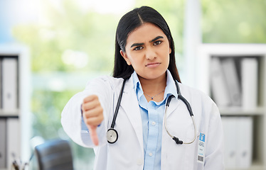 Image showing Doctor, stop and thumbs down with medical healthcare professional in hospital consulting office. Fail, poor research, or bad news with pharmacist, psychologist or medicine technician