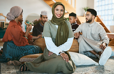 Image showing A happy Muslim woman sitting, with family and celebration of culture during Ramadan. A modern Islamic lady with a smile, beauty and in a hijab to celebrate holiday and eat together and home for Eid