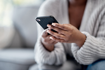 Image showing Closeup of woman hands typing on phone, sending a text message online on social media on home sofa. Female reading and replying to a work email. African American lady playing a game on mobile device.