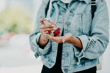 Image showing Closeup of woman using hand sanitizer while in public or travelling with copy space. Female practicing good health and hygiene, sticking to corona regulations. Lady suffering from OCD or germ phobia