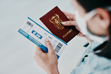 Image showing Travel, covid and tourist visa or passport while holding a plane flight ticket with face mask at airport for immigration. Closeup of female traveler holding ID for traveling during corona pandemic