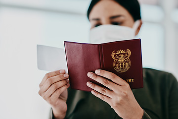 Image showing Travel, covid passport and restrictions while holding flight ticket and pass with face mask at airport. Closeup of female hands holding identification for immigration during coronavirus pandemic