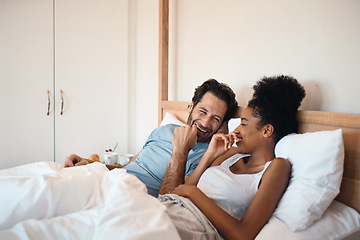 Image showing Happy, silly and goofy couple bonding in bed, sharing intimate relationship joke and moment. Young interracial husband and wife laughing, loving and enjoying lazy morning relaxing indoors together