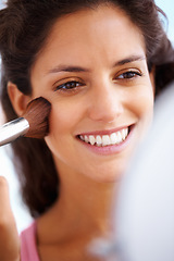 Image showing Beauty, grooming and makeup with woman apply blush to her face, happy and looking in a mirror at home. Young female excited to try skin cosmetics, smiling and getting ready, satisfied with results