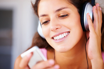Image showing Music, podcast and streaming with a woman listening to audio on the radio with headphones. Relax, freedom and beauty with a young, happy female giving a smile and holding a digital device for a track